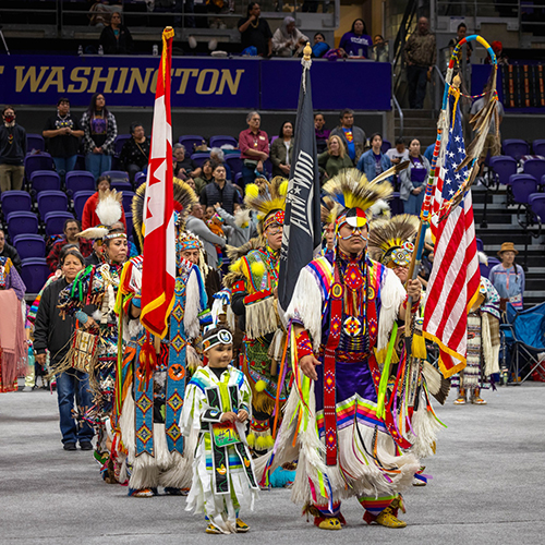 Powwow event procession of people in regalia