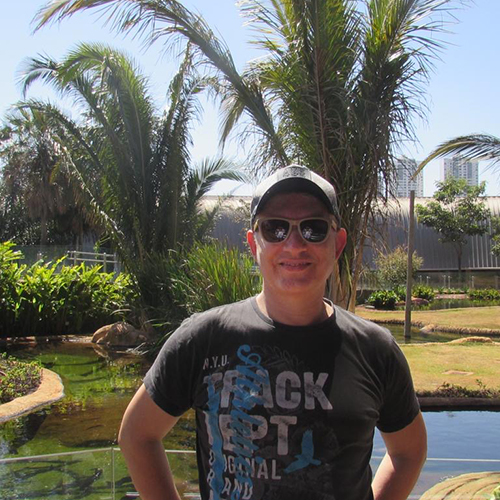 Eduardo Viana da Silva in Brazil, with water and palm trees in the background.