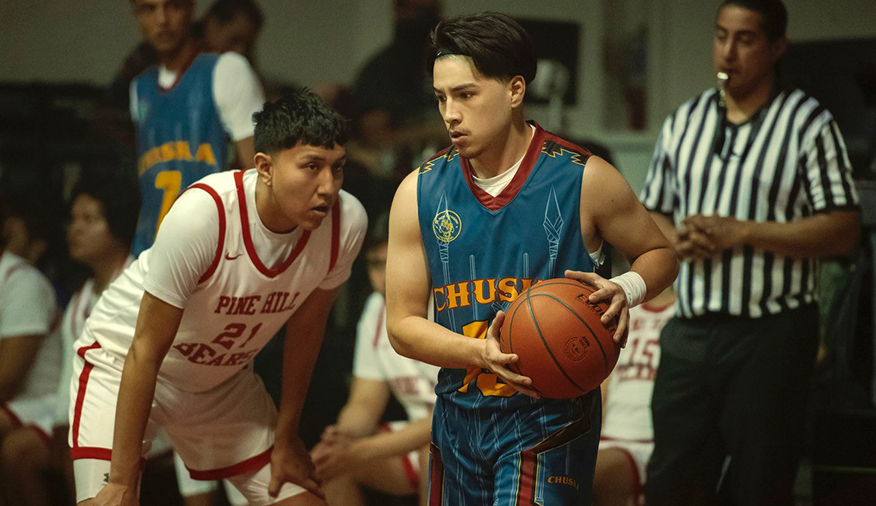 Two high school basketball players on the court