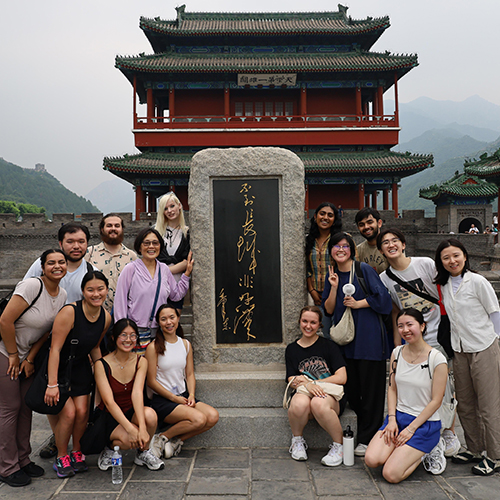 About a dozen UW students posing along the Great Wall in China.