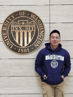 Andri Fernanda standing in front of a University of Washington sign