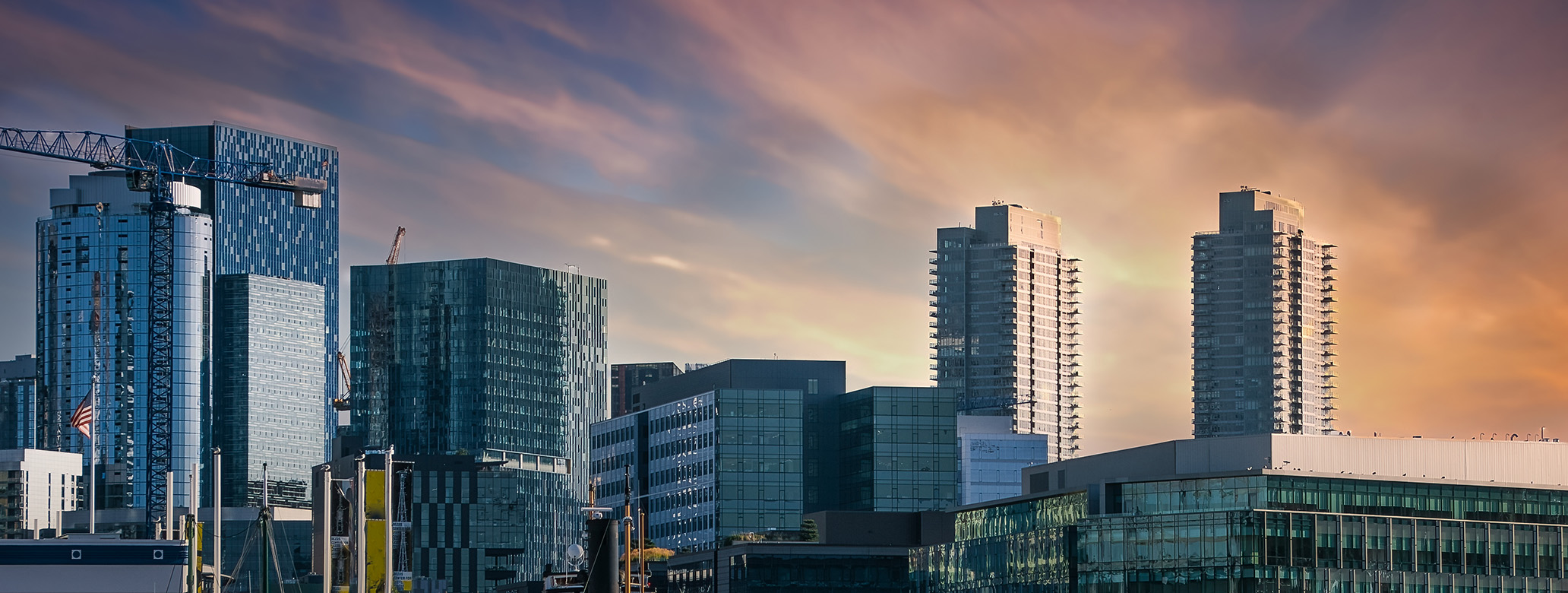 Panoramic view of Seattle's South Lake Union area with dramatic clouds above.