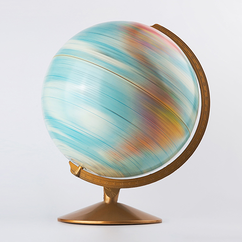 A colorful globe spinning in a globe stand