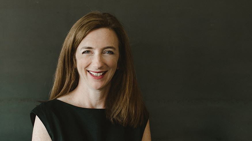 Portrait photo of Kristine Matthews, with very dark background