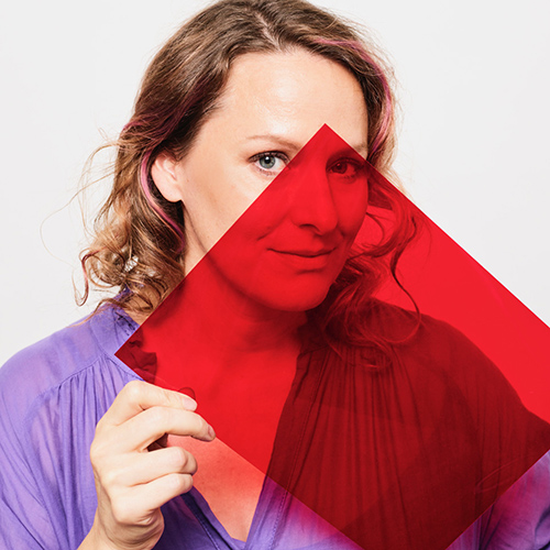 Photo of Carrie Shaw holding a translucent red square.