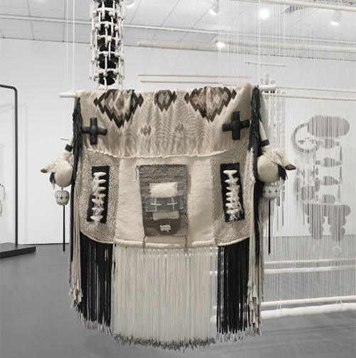 Large freestanding woven sculptural artwork in earth tones