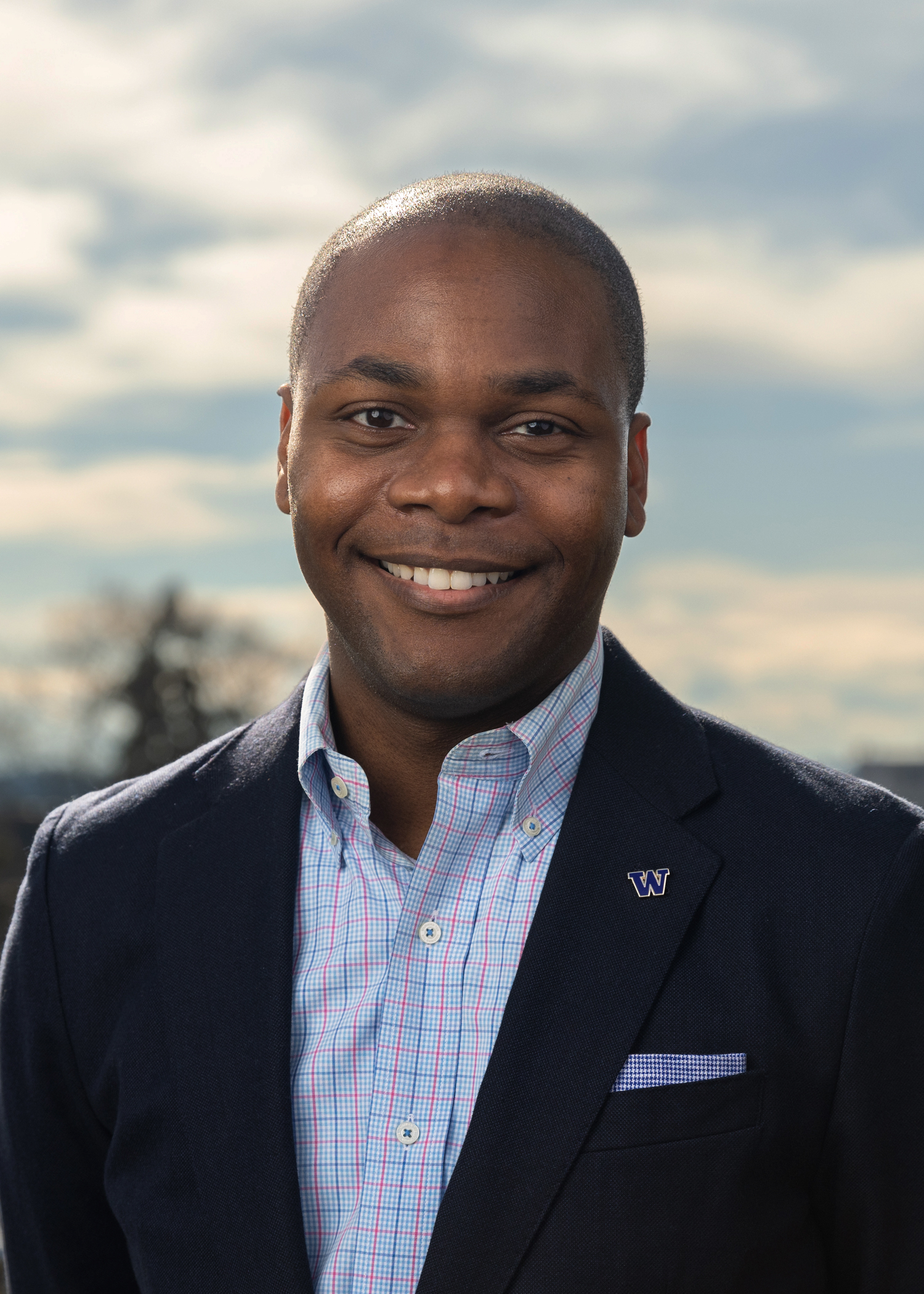 A smiling man in an attractive suite.