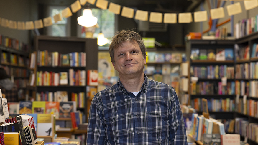Tom Nissley with bookshelves behind him.
