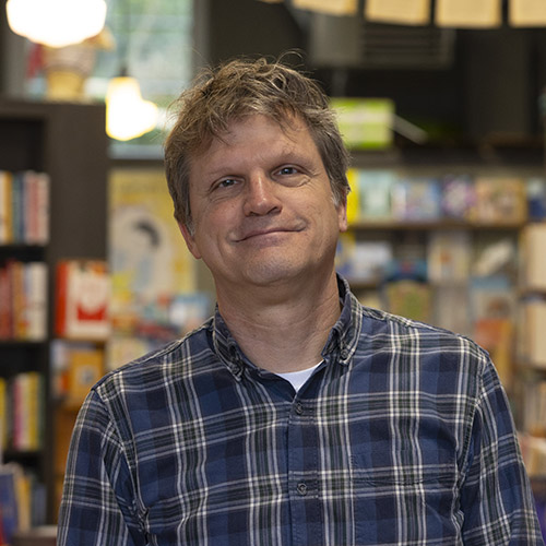 Tom Nissley with bookshelves behind him.
