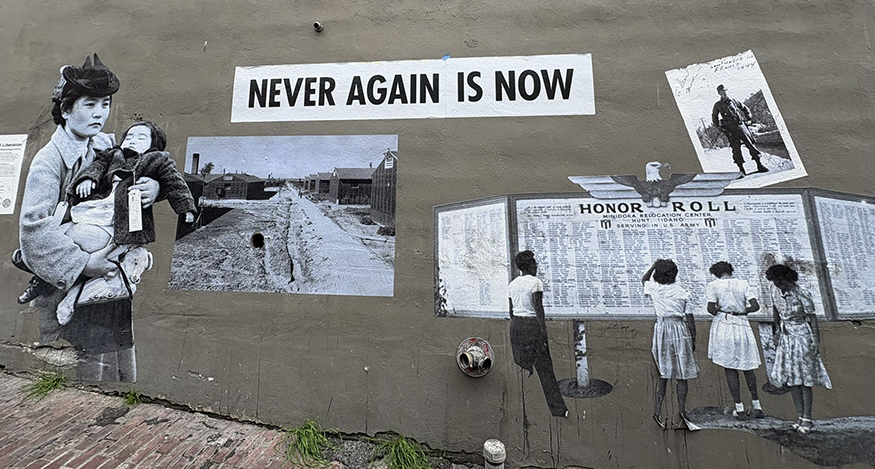 A mural in Seattle's Chinatown-International District, which includes the words "Never Again in Now."