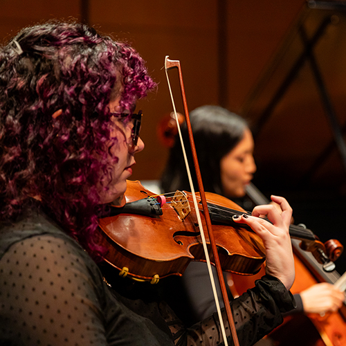 Violinist performing in Modern Music Ensemble rehearsal