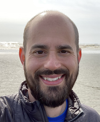 Headshot of David Masiello with a sandy beach in the background.
