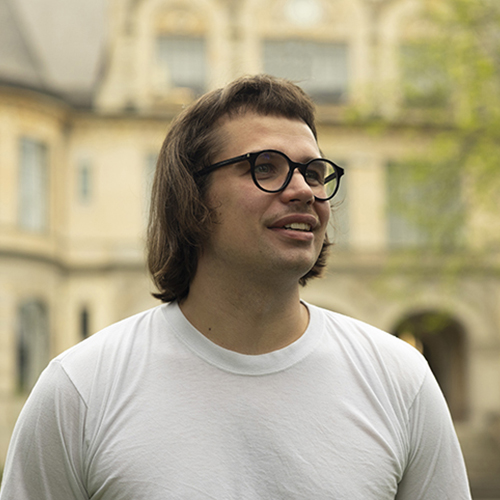 Greg Rahuoja on the UW campus, with Denny Hall in the background.