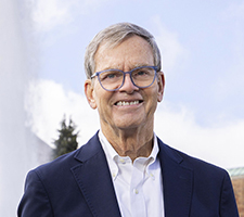 Gregg Blodgett on the UW campus, with the plume of Drumheller Foundation to his left. 