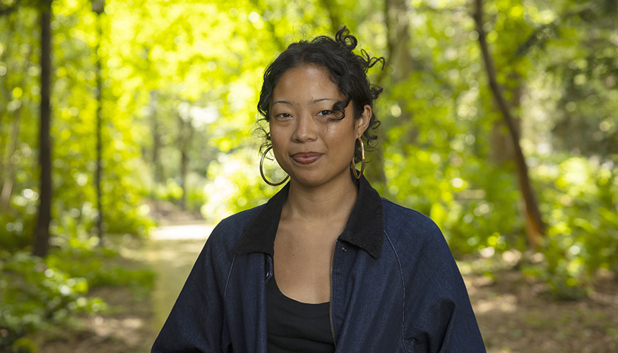 Raquel Matthews on the UW campus, with trees in the background. 