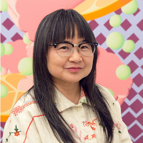 Charlene Liu in front of one of her colorful artworks.