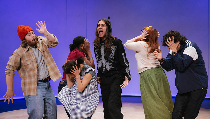 In the play "Everybody," an actor wearing a skeleton suit shouts while other characters cover their ears with their hands. 