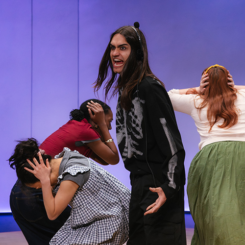 In the play "Everybody," an actor wearing a skeleton suit shouts while other characters cover their ears with their hands. 