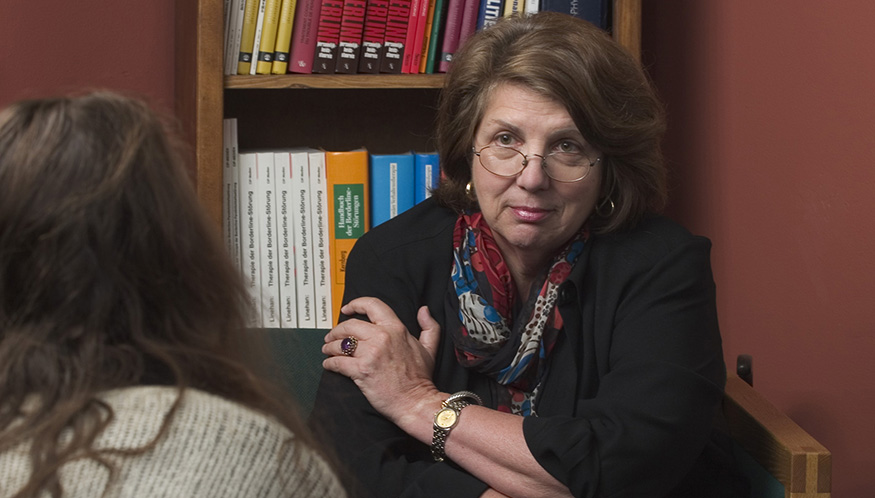 Marsha Linehan listening to a patient who is viewed from the back.