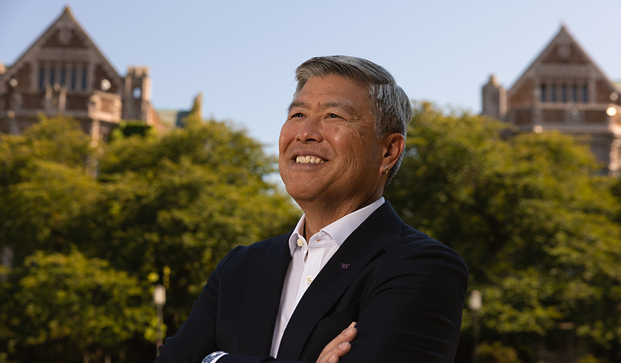 Dean Maeda poses smiling on the UW quad.
