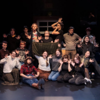Drama students pose on stage