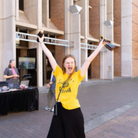 Student cheers outside of the Meany Center Dawg Daze table.
