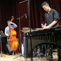 Jazz combo members play instruments on stage