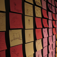 Colorful sticky notes with drawings on a wall