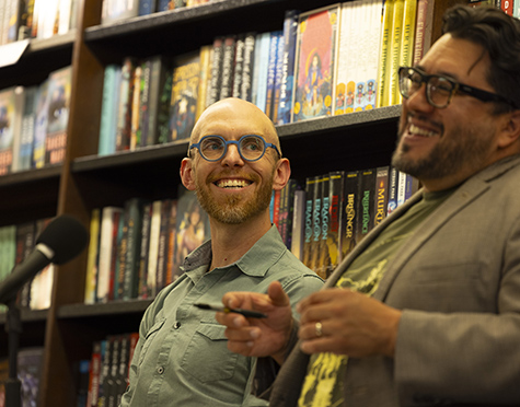 Professors Colin Marshall and Jose Jorge Mendoza in front of bookshelves in a bookstore.  