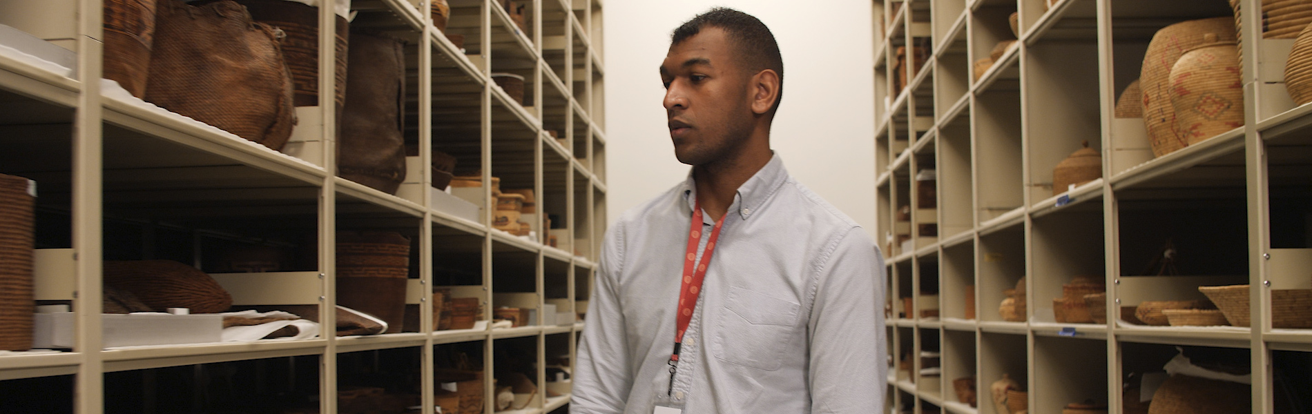 Student looking through shelves of historical items and documents